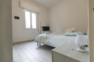 A bed or beds in a room at M.G Home a un passo da tutto