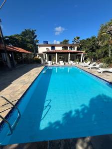 a large swimming pool in front of a house at Sítio com Piscina em Aldeia in Camaragibe