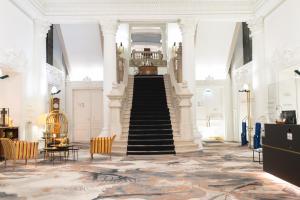 - un escalier dans un bâtiment avec un escalier dans l'établissement Grand Hôtel Du Tonneau D'Or, à Belfort