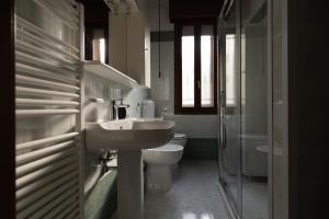 a bathroom with a sink and a toilet and a shower at M.G. Home 2 a un passo da tutto in Bologna +31 photos