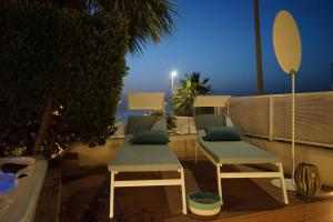 two chairs and a table on a balcony at Anemos Suites Macari - San Vito Lo Capo in Macari