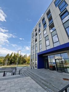 a building with a staircase in front of it at Smart Loft Apartment in Tuzla