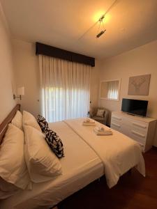 a bedroom with a large bed and a television at IL PARCO 2 in Rome