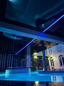 a swimming pool with blue lights in a building at Jarzębinowy Resort & SPA in Braniewo
