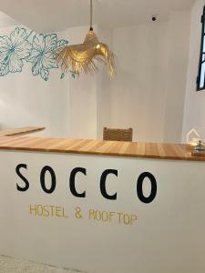 a sign for a hotel and roof top at Socco Hostel in Tangier