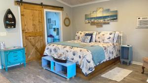 a bedroom with a bed and a blue nightstand at The Beach House at Si Como No Inn in Flagler Beach