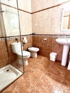 a bathroom with two toilets and a sink at Villa Skiba Es Caló Formentera in Es Calo