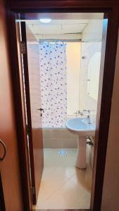 a bathroom with a sink and a shower at Deluxe Couple Partition Room in Tecom Near Metro in Dubai