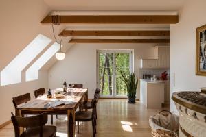 a kitchen and dining room with a table and chairs at SCHILCHERLANDLEBEN - Langegg in Greisdorf +66 photos