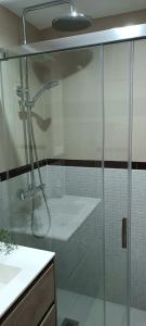 a glass shower in a bathroom with a sink at Valparaiso8 in Oropesa del Mar