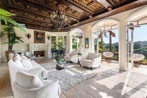 a living room with white furniture and a fireplace at Bel Air Luxury Villa in Los Angeles