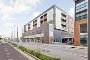 a rendering of a building on a city street at CozySuites l Trendy 2BR, Bottleworks Indy #1 in Indianapolis
