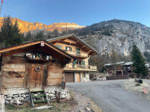 a large wooden house on the side of a road at Chalet Lou Via location in Abondance