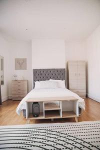 a bedroom with a bed with a white bed frame at 2 New bed flat in hammersmith in London