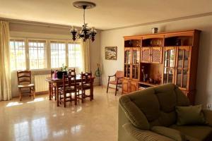 a living room with a couch and a table and chairs at Casa Polícar Marta in Polícar