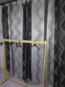 a curtain rack in a room with black curtains at Piyo Vida Guesthouse in Ahangama