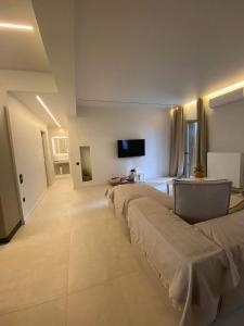 a room with three beds and a tv on the wall at Sapfo Luxury Apartment in Athens in Athens