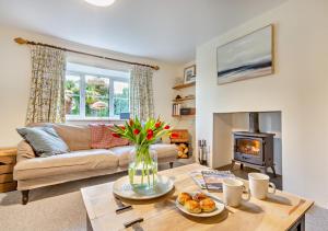 a living room with a couch and a fireplace at Tan Yr Orsedd in Abersoch