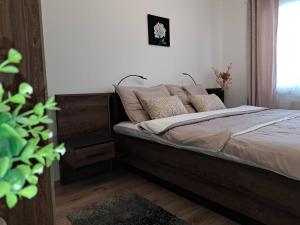 Un dormitorio con una cama con almohadas. en Orient Apartmanház en Eger