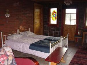a bedroom with a bed and a stained glass window at Rinne in Rymättylä