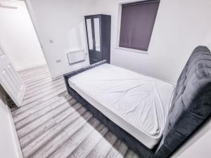 a large bed in a room with a window at Elegant City Apt: 1-BR Luxury in Wolverhampton