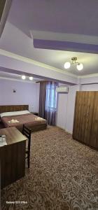 a room with two beds and a table in it at Hotel international in Yerevan