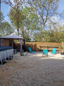 a group of chairs and a table and a tent at T2 Jacuzzi Disneyland Paris Résidence Belle Créole in Quincy-Voisins