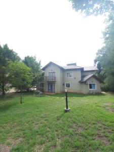 a house with a sign in the yard at Tantanakuy 2 in Villa General Belgrano