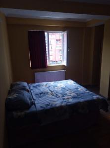 a bedroom with a bed in front of a window at vake-house in Tbilisi City