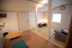 a room with a mirror and a table and a clock at Otaro Village - Vacation STAY 63281v in Otaru