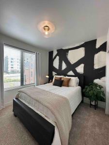 a bedroom with a large bed and a large window at Spacious TH w/ Firepit, Mountain Views & Garage in Denver