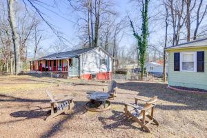 two benches and a table in front of a house at Pet-Friendly Georgia Retreat with Fire Pit and Porch! in Forest Park