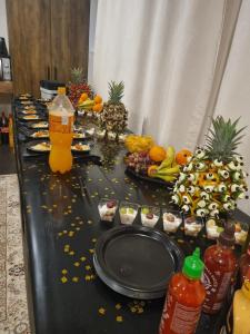a table with plates of food and fruit on it at Private Luxury Club in Poznań