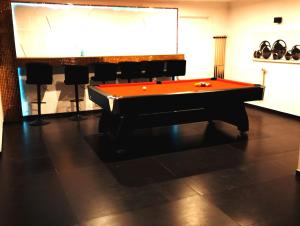 a pool table in a room with a projection screen at Private Luxury Club in Poznań