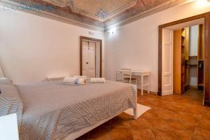a bedroom with a bed and a table at Carlo Alberto Apartment, Alghero old town, near the beach in Alghero