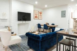 a living room with a blue couch and a table at 3BR 2Baths with Private Outdoors in New York