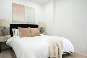 a white bedroom with a large white bed with pillows at 3BR 2Baths with Private Outdoors in New York