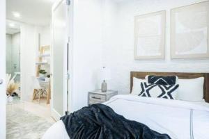 a white bedroom with a large white bed in a room at Brand new 2BR 1Bath East Village in New York