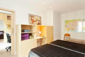 a bedroom with a bed and a desk in it at Classy 3bed 3bath apartment in Eixample in Barcelona