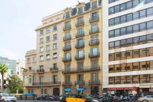 a large building with cars parked in front of it at Classy 3bed 3bath apartment in Eixample in Barcelona