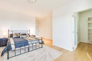 a white bedroom with a bed and a rug at Bright Chicago Home with Backyard Less Than 5 Mi to Downtown in Chicago