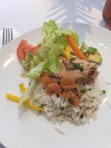 a plate of rice with chicken and vegetables on it at Nomusa's Bed and Breakfast in Richards Bay