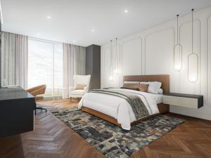 a bedroom with a bed and a living room at Terre Haute Casino Resort in Terre Haute