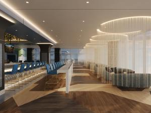 a lobby with blue chairs and a bar at Terre Haute Casino Resort in Terre Haute