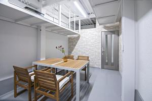 a dining room with a wooden table and chairs at UMI-Haven Fukushima - Vacation STAY 16109 in Osaka