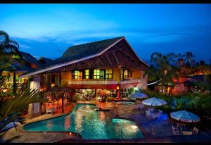an exterior view of a resort with a swimming pool at Beira mar Flat 2-209 in Ilhabela