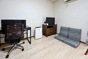 a room with a desk and a chair and a television at Rose Park Nibankan - Vacation STAY 71056v in Funabashi