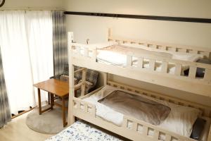 two bunk beds in a room with a desk at Rose Park Nibankan - Vacation STAY 71056v in Funabashi