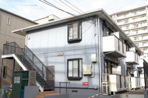 a white building with stairs on the side of it at Rose Park Nibankan - Vacation STAY 71056v in Funabashi