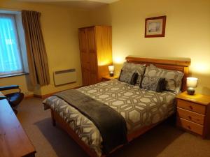 a bedroom with a bed and a dresser and a window at 8 Firth Square in Kirkwall